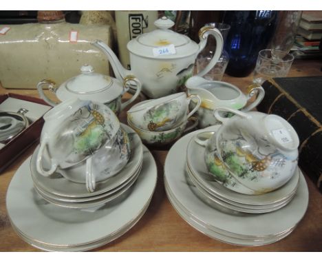 A part tea service in egg shell China with enamel detail scenes