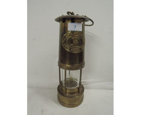 A vintage brass bodied miners lamp made by E Thomas & Williams Aberdale. Cambrian No.9582