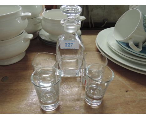 A miniature shot glass and decanter set for two