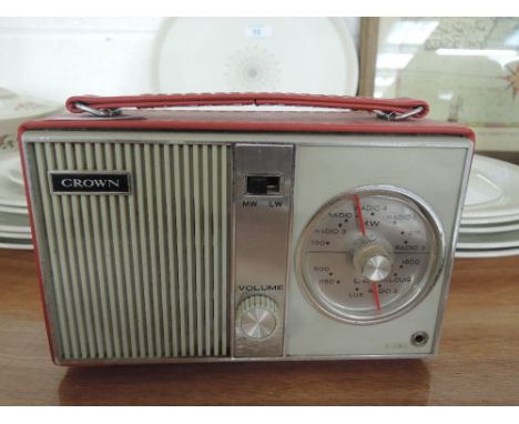 A vintage portable Crown radio with red vinyl body model no. TR 602 L