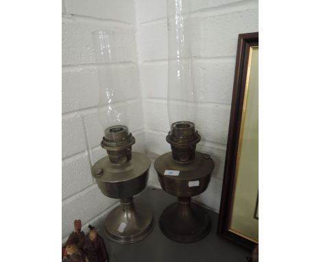 Two vintage metal bodied oil burning lamps made by Aladdin lamp co.