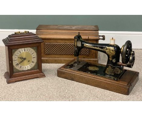 CASED VINTAGE SINGER HAND CRANK SEWING MACHINE, and a modern bell strike bracket-type mantel clock, 29cms H, 26cms across the