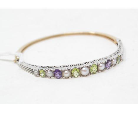 A 9ct gold, silver, cultured pearl, peridot and amethyst bangleReport by NGThis is a modern bangle. Inside measurements appro