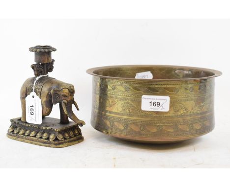An Islamic brass bowl, with engraved decoration, 21.5 cm diameter,  and a similar elephant candlestick, 14.5 cm high (2) 