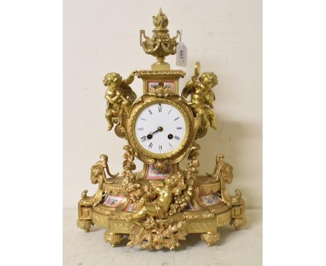 A French ormolu mantel clock, the white enamel dial with Roman numerals, fitted a movement striking on a bell, the case decor