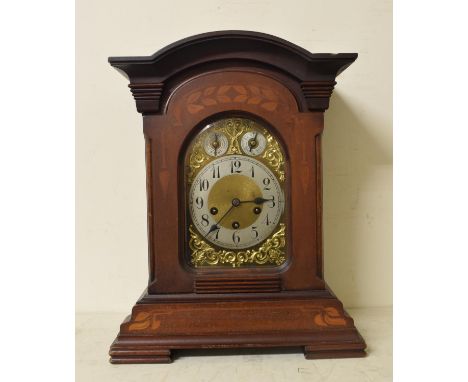 A mantel clock, the brass dial with silver chapter ring with Arabic numerals, CHIME/SILENT DIAL and FAST/SLOW dials, fitted a