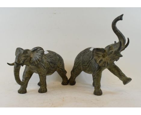 A metal elephant, trunk in salute, 22cm high, (2) 