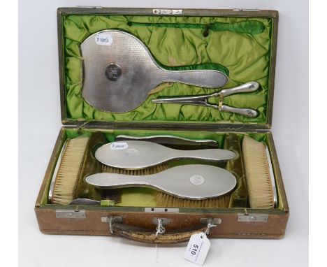 A silver travelling dressing table set, with engine turned decoration, initialled, Stokes & Ireland, Chester 1912, cased 