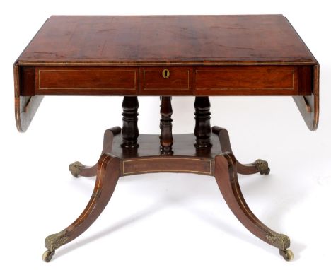 A Regency rosewood sofa table, with brass stringing having a frieze drawer on baluster turned supports, a concave sided platf