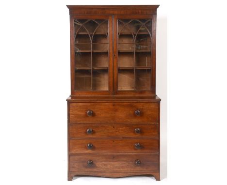 An early 19th century mahogany secretaire bookcase, the moulded cornice above a pair of lancelet bar glazed doors, the base w