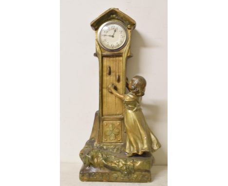 A mantel clock, with Arabic numerals, in a composition case in the form of a child and a longcase clock, 53 cm high, three ma