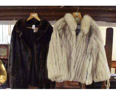 A lady's mink fur coat, bears a label William & Hopkins Ltd Bournemouth, a fox fur jacket, a lady's black fur jacket, a lady'