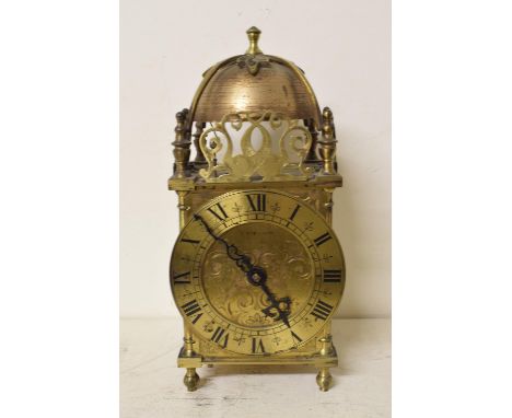 A 17th century style brass lantern clock, with Roman numerals, 26 cm high, and an Edwardian mantel clock, in an inlaid balloo