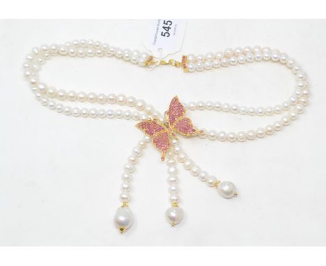 A two strand cultured pearl necklace, with a gold plated and ruby butterfly pendant 