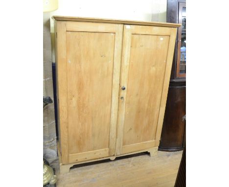 A pine two door kitchen cupboard with shelves, 133 cm wide, two corner cupboards, three pine chairs, an Eastern embroidery, o