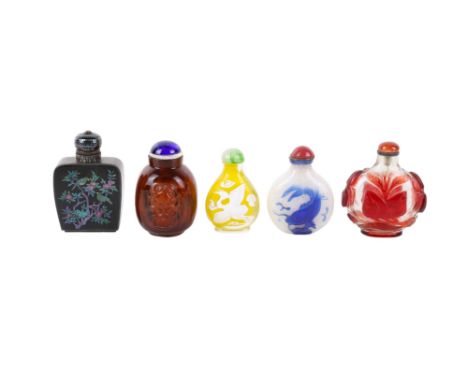 Five Chinese snuffbottles. Four of glass including one of amber colour with inside painting of figures, one of white snow gla