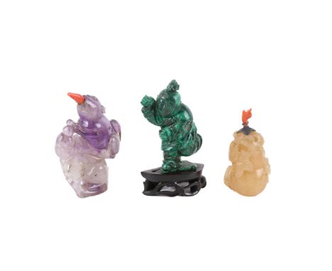 Three Chinese snuffbottles. Including a beige jade double gourd, one of malachite of a child running attached to a wood stand