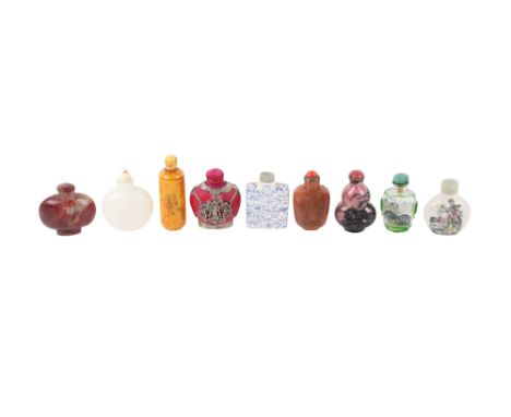 A group of nine assorted 20th century Chinese snuffbottles. Including stoneware, glass and stone examples, one with inside pa