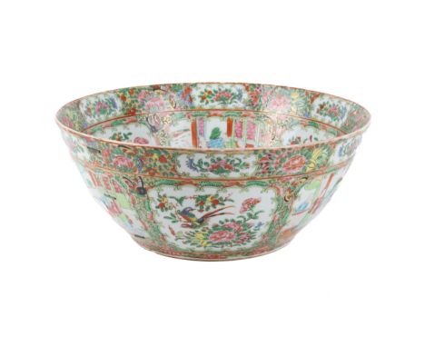 A circa 1900 Chinese Canton enamel punch bowl. Decorated with shaped reserves of figures and birds, surrounded by leaves, flo