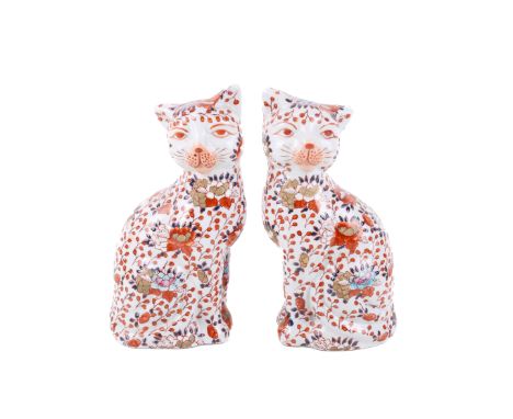 A pair of early 20th century Japanese ceramic cats. With Imari decoration of red and blue flowers, marked to base. H19.5cm.