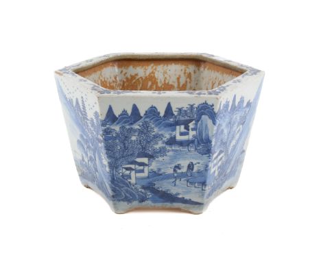 A Chinese blue and white hexagonal planter. Decorated with figures and dwellings in the edge of the water in a rocky landscap