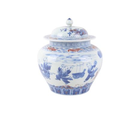 A 20th century lidded jar. Decorated in underglaze blue and red with children playing amongst trees. Qianlong mark to base bu