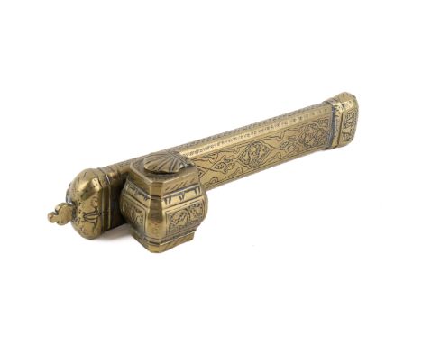 A Middle Eastern brass travelling scribe case. A shell in relief to the inkwell lid, overall engraved with calligraphy amid l