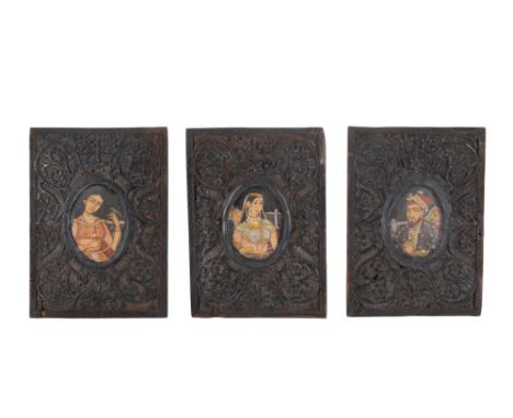 Three Indian miniature portrait paintings. Mounted in wood panels carved with scrolling flowering branches, framed size 15.5c