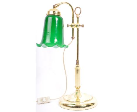 A vintage mid 20th century table lamp. The lamp having green glass tulip shade on a brass hooped frame with gadrooning to bas