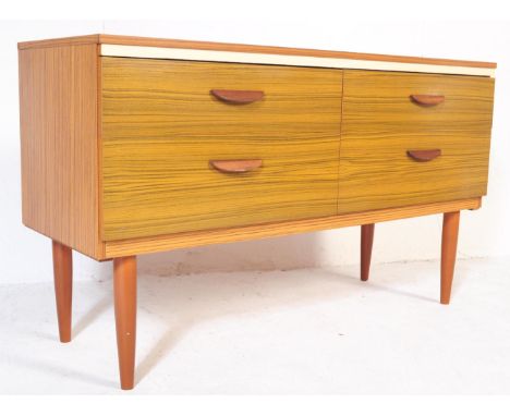 A retro vintage mid 20th century Formica sideboard credenza having twin banks of double drawers, each being raised over taper