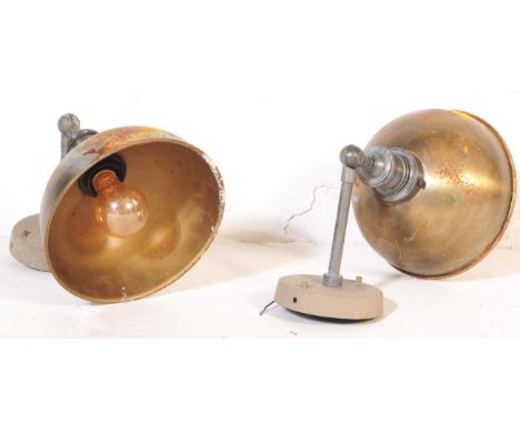 A pair of retro vintage mid 20th century industrial factory metal wall lights. With shaped shade with angled arm and circular