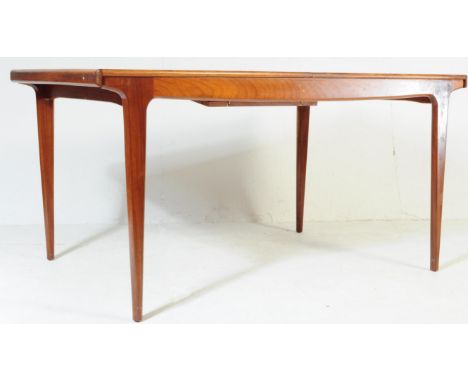 A vintage mid 20th century elm wood extending dining table. Of rectangular form with tapering circular supports. Measures app