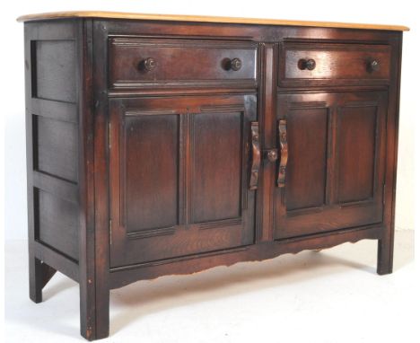 A vintage 20th century Ercol elm wood sideboard. With curved rectangular light wood top, with two parallel drawers above twin