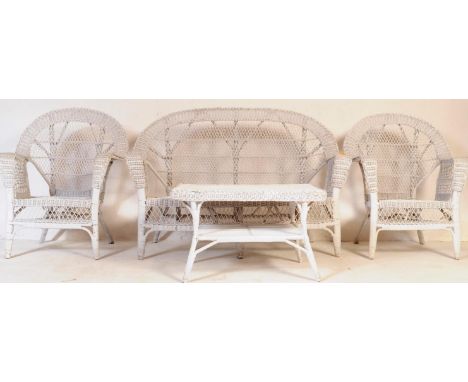 A retro vintage 20th century white painted wicker rattan garden conservatory four piece suite comprising of two seater settee