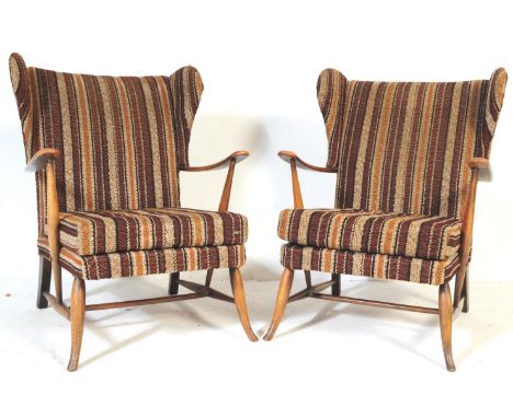 A pair of retro vintage mid 20th century beech Ercol wing back arm chairs. Having&nbsp; rectangular straight backrest flanked