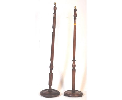 A pair 20th Century circa. 1930's solid wood floor standing lamp stands. Fully carved body detailing on solid wood circular t