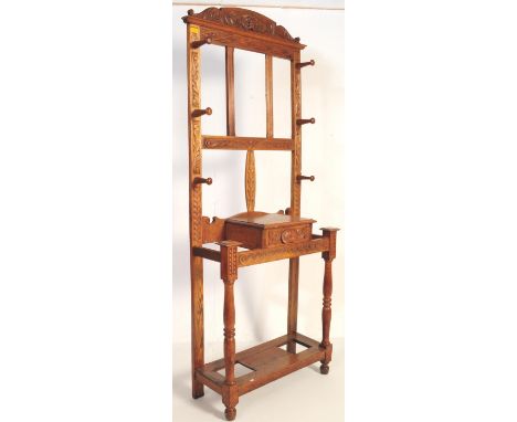 An early 20th century circa 1930’s light oak hall stand. The stand having an ornate carved lions head with associated scrolli