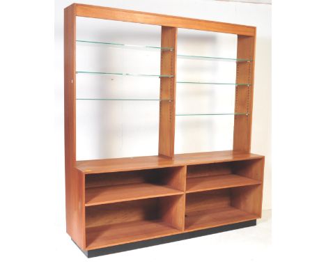 A retro vintage mid 20th century teak double wall bookcase unit having a twin set of three shelves bookcase over a double cup