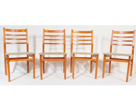 A set of four retro vintage mid 20th century teak wood dining chairs. With horizontal back rests on a cushioned upholstered s