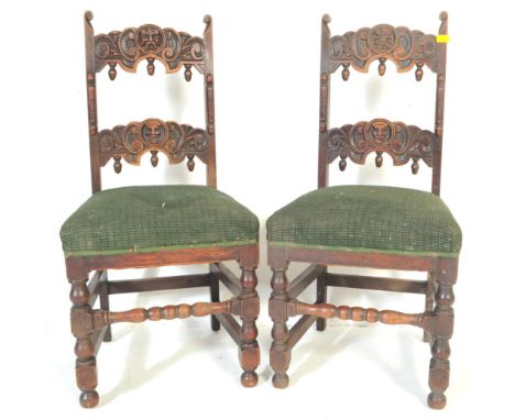 A pair of 19th century Carolean revival 17th century style gothic oak hall chairs having top rail carved with central Green M