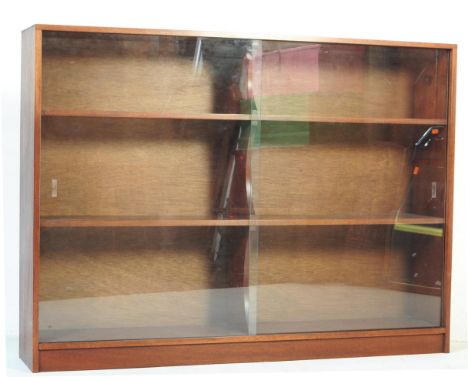 A retro vintage mid 20th century mahogany lawyers barrister book case. Of rectangular form with twin sliding glass doors with