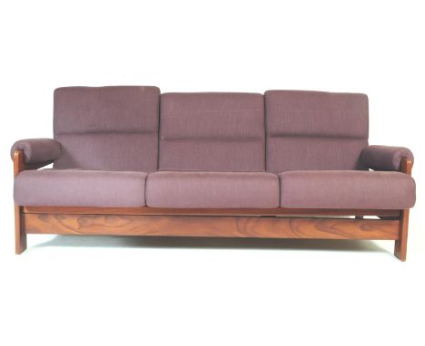 A retro vintage mid 20th century teak wood sofa bed settee. With purple upholstered cushioned back rest and seats with rectan