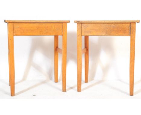 A pair of vintage 20th century beech wood school desks table. Of rectangular form with metal hinged fixing opening to reveal 