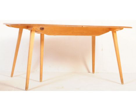 Lucian Ercolani - Ercol - A retro vintage mid 20th century teak extending dining table having a shaped&nbsp; top raised on ta