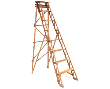 A vintage 20th century industrial wooden folding ladder with hinged supports and metal makers plaque. Measures approx. 216cm 