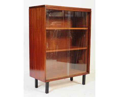 A retro vintage mid 20th century teak wood display bookcase cabinet. Rectangular form with twin glazed sliding doors with she