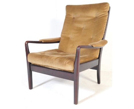 A retro vintage mid 20th century lounge arm chair. Having rectangular button back back rest, padded curved arm rest in a gree