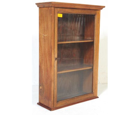 A vintage 20th century circa. 1950's wooden medicine shop cabinet having single glazed door opening to reveal shelved interio