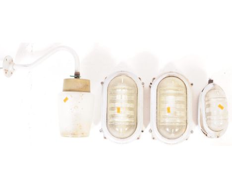 A collection of four vintage retro mid 20th century industrial glass and galvanised metal bulkhead lights. Each having presse