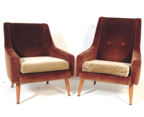 A pair of retro vintage mid 20th century brown lounge arm chairs. With rectangular upright back rest, curved arm rests with d